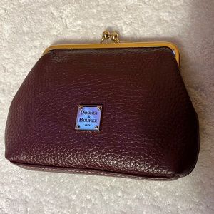 Dooney and Bourke wine colored coin purse with slots for credit cards.